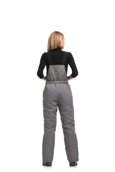 Woman in gray working overalls rearview — Stock Photo, Image