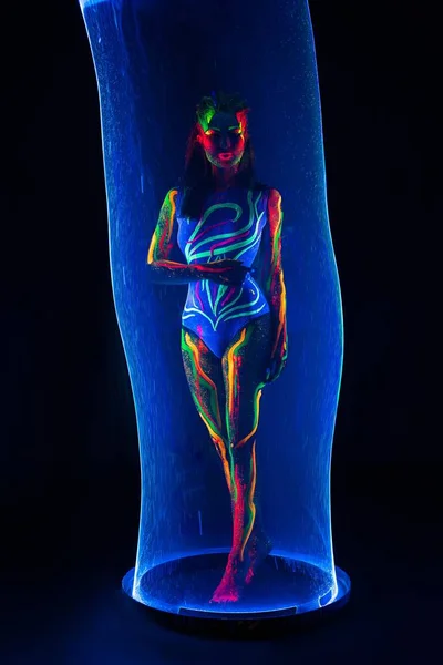 Female model with colorful body in tube — Stock Photo, Image