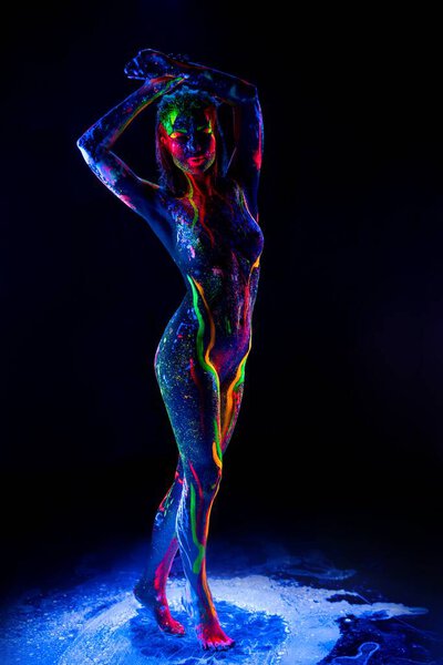 Nude woman portrait with colorful fluorescent glowing body art