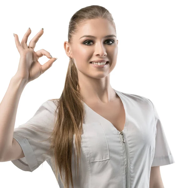 Hermosa enfermera en uniforme blanco símbolo OK — Foto de Stock