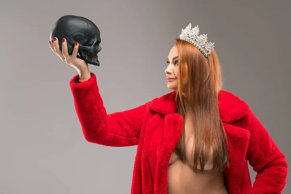 Sexy rainha olhando para preto humano crânio — Fotografia de Stock