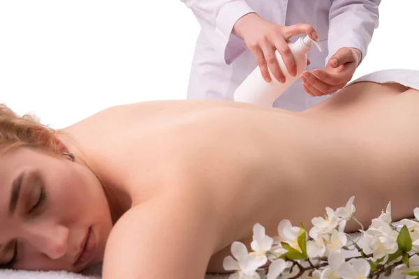 Crop masseur applying cream before massage in salon — Stock Photo, Image