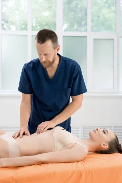 doctor osteopath demonstrate treating patient