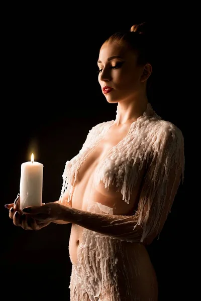 Topless woman look at carrying candle — Stock Photo, Image