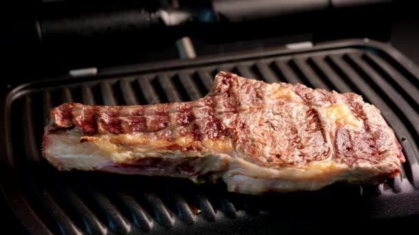 Соковитий шматок яловичого стейка на грилі, приправлений спеціями — стокове відео