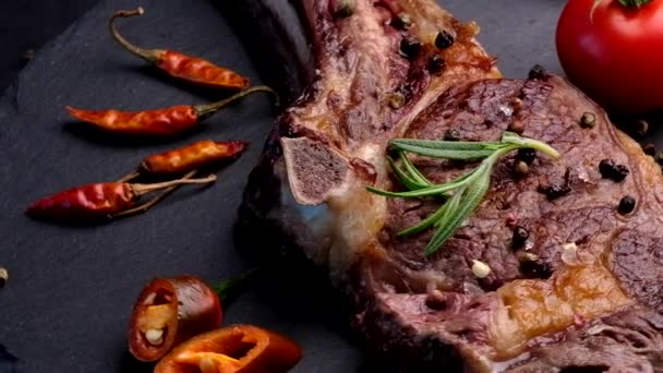 Grilovaný hovězí steak na kosti s rajčaty — Stock video