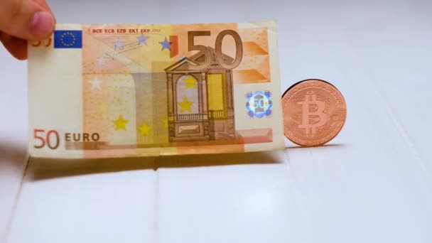 Bitcoins and banknote on white table — Stock Video