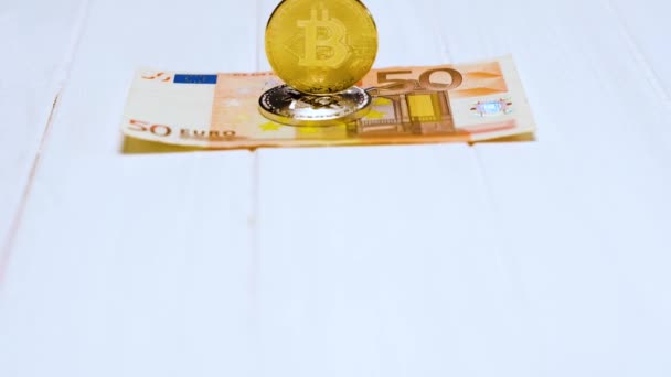 Bitcoins and banknote on white table — Stock Video