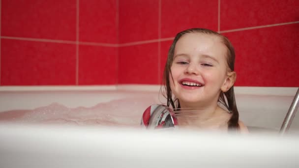 Küçük kız banyoda çekerken duş eki ile oynarken — Stok video