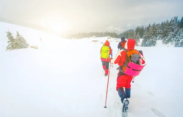 Escursionisti diretti verso baite coperte di neve — Foto Stock