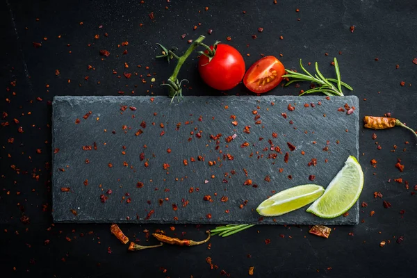 Gray textured board with vegetables — Stock Photo, Image
