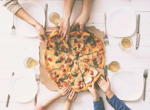 Four hands taking pieces of pizza — Stock Photo, Image