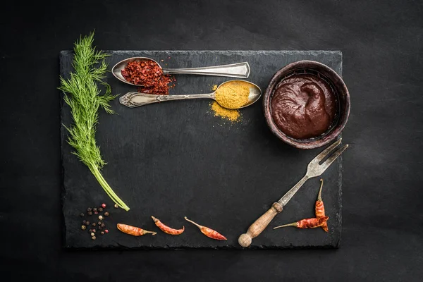 Black slate board with spices — Stock Photo, Image
