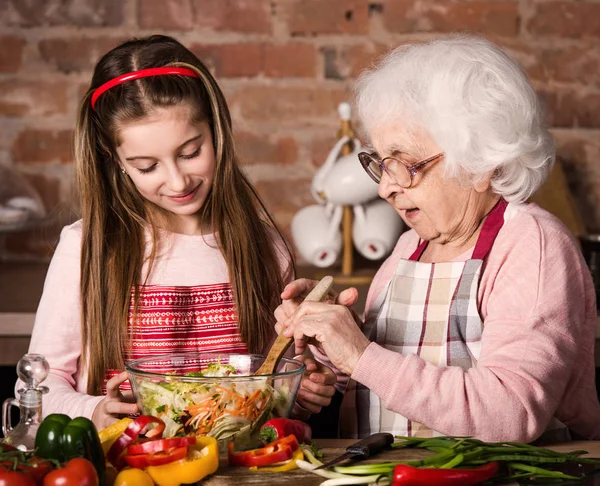 Grandmother and granddaughter cooking together