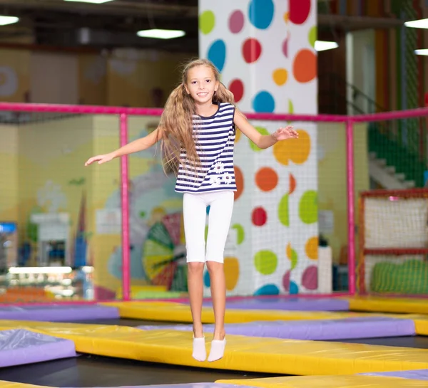 Little excited girl photographed at the jump on the trampoline — Stock Photo, Image