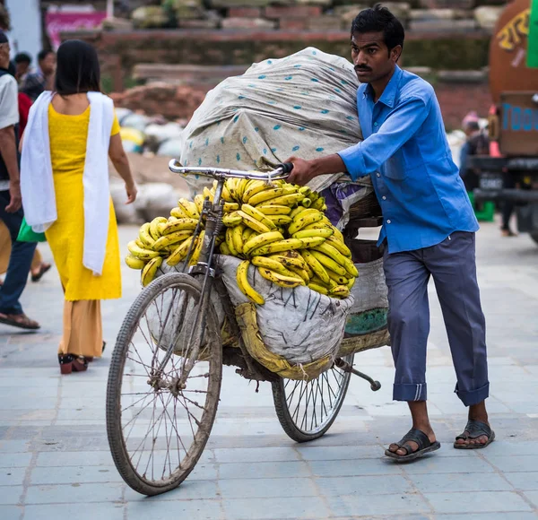 L'uomo vende banane su una bicicletta in un mercato di strada — Foto Stock