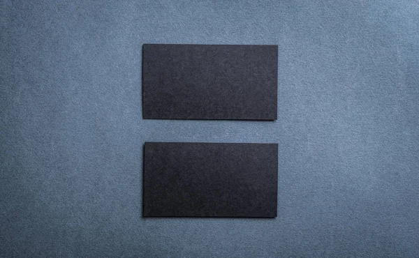 Black blank business card template on dark background.