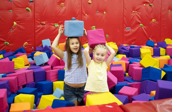 Little girls sitting in the playroom — Stock Photo, Image