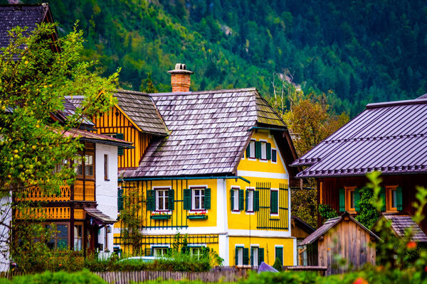 Yellow old building at the rocky mountain in Hallstatt, Austria