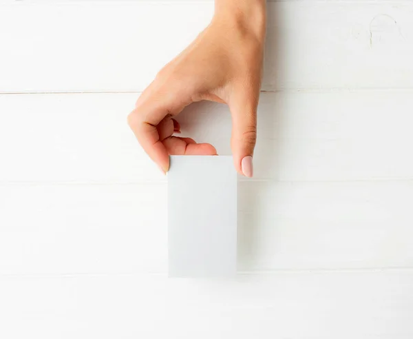 White business card in girl hands — Stock Photo, Image