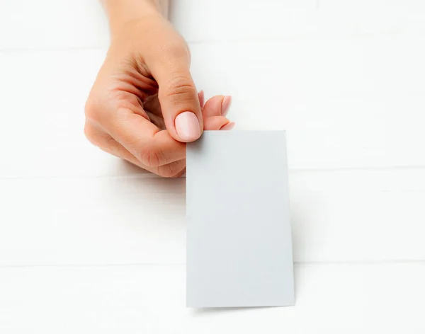 White business card in girl hands — Stock Photo, Image