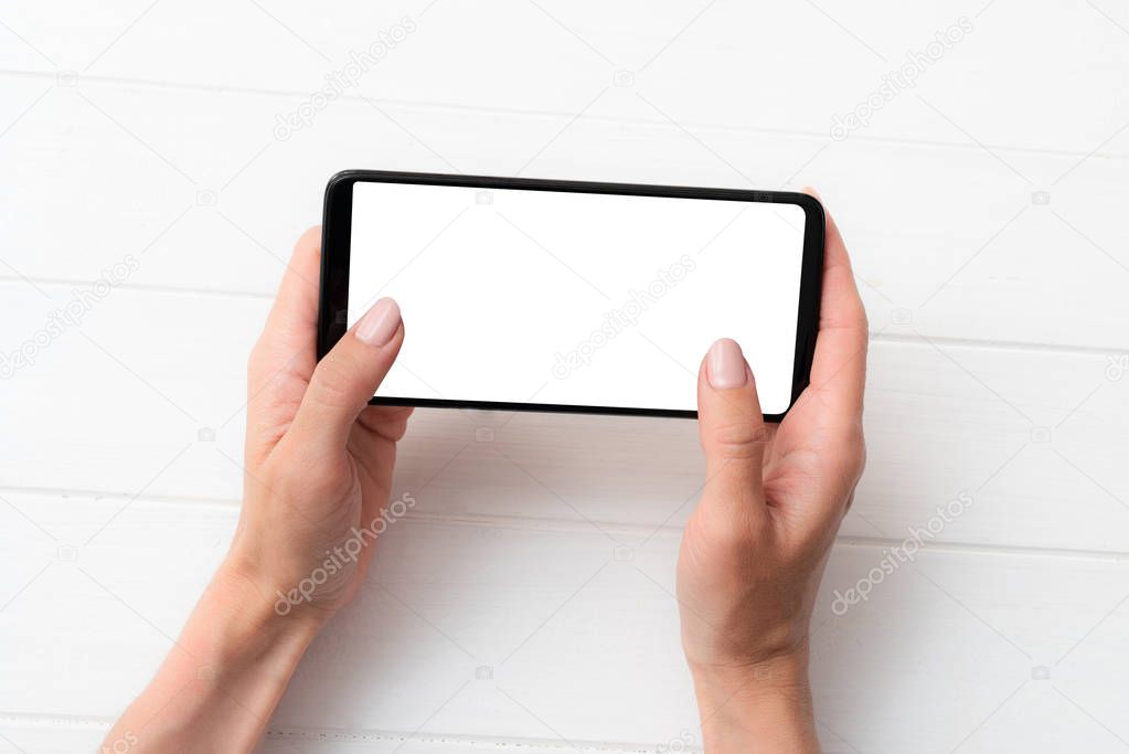 Mock up of black smartphone in hands for your design