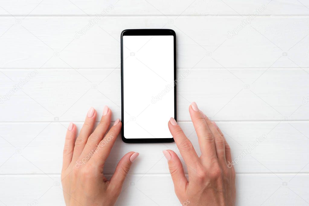 Black smartphone with white screen in hands