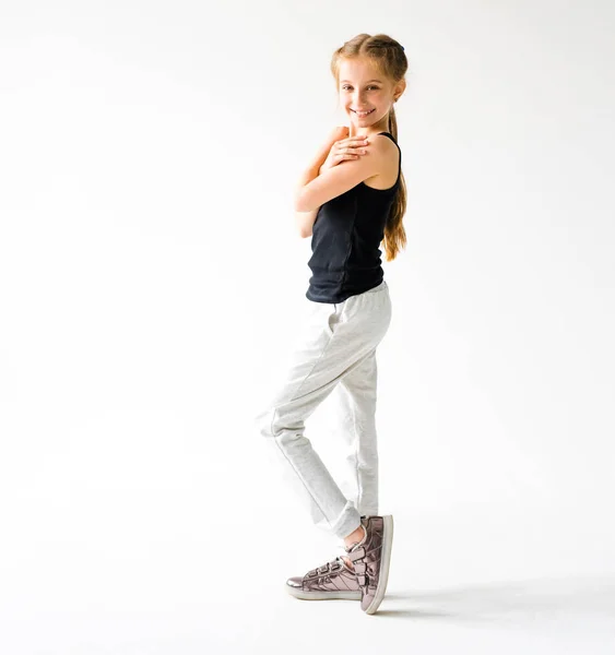 Little girl smiling standing in front of camera — Stock Photo, Image