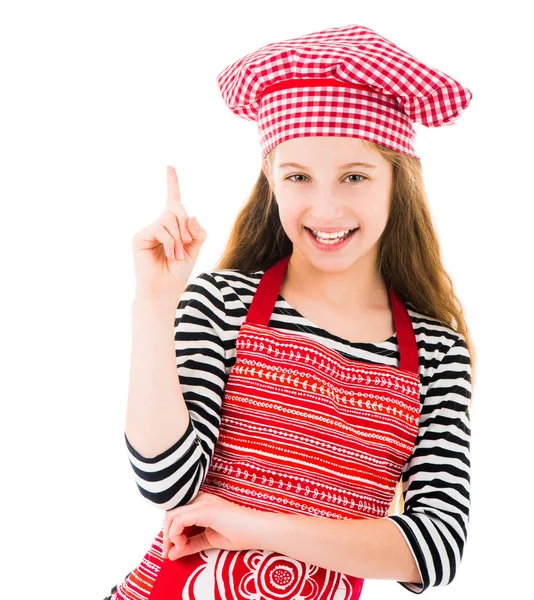 Girl in kitchen upron pointing up — Stock Photo, Image