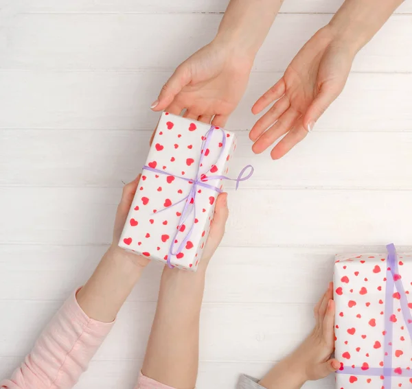 Girls hands holding lovely present box — Stock Photo, Image