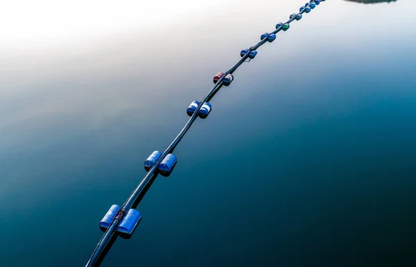 Aerial view of blue tube with barrels on the lake — Stock Photo, Image