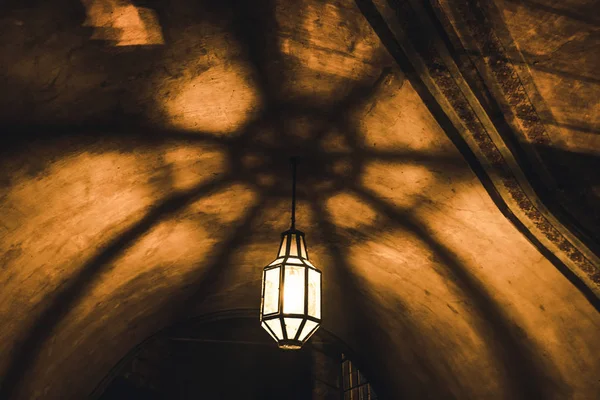 Light from the lamp and the shadows in the mysterious corridor in old dungeon — Stock Photo, Image