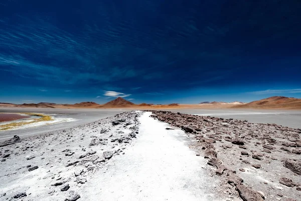 Rocky road among Bolivian desert — Stock Photo, Image