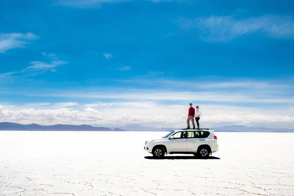 Tourists on car rooftop in Salar de Uyuni — Stock Photo, Image