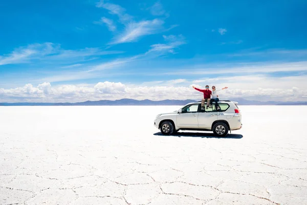 Tourists on car rooftop in Salar de Uyuni — Stock Photo, Image