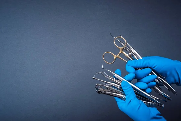 Manos en guantes azules que sostienen equipo dental de metal — Foto de Stock