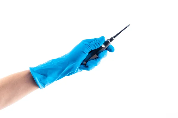Ręka w niebieską rękawicę, która trzyma instrument dentystyczny na białym tle — Zdjęcie stockowe