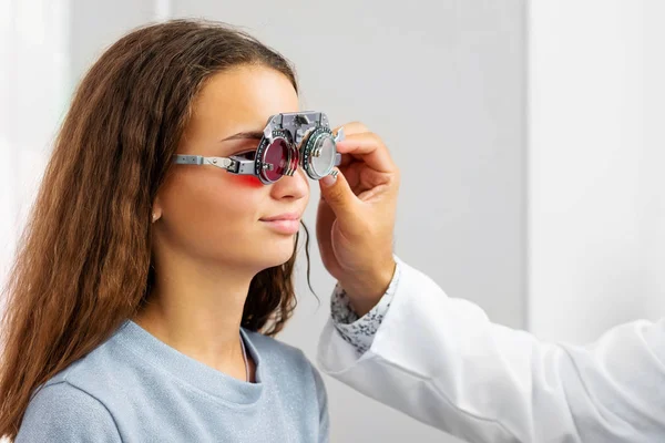 Doctor holding special eye equipment — Stock Photo, Image