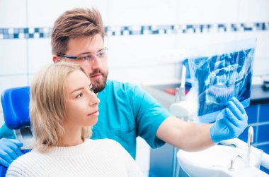 Doktor röntgen görüntüsü gösteriyor.
