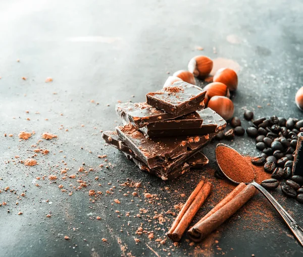 Chocolate, nuts, spices on table — Stock Photo, Image