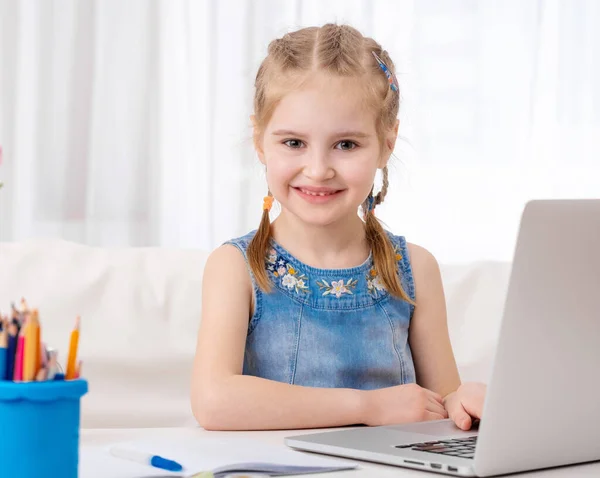 Liten flicka som använder sin bärbara dator — Stockfoto