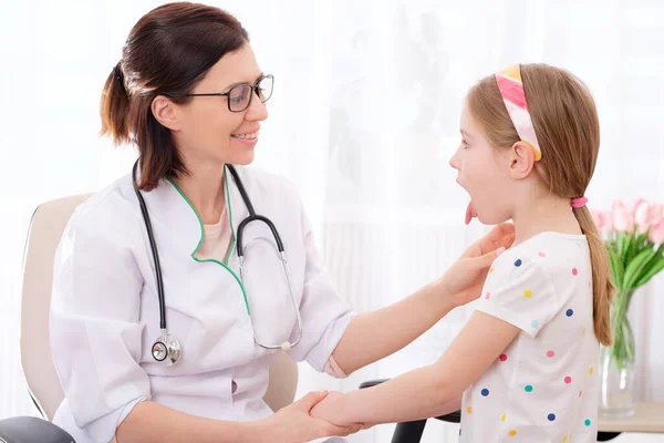 Physician checking girls glands — Stock Photo, Image