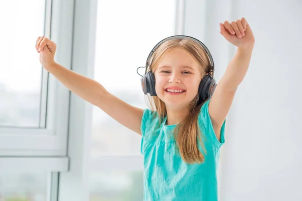 Happy little girl in headphones — Stock Photo, Image