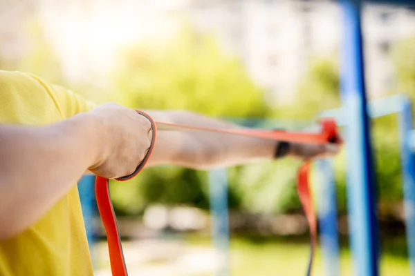 Man exercising with resistance rubber band