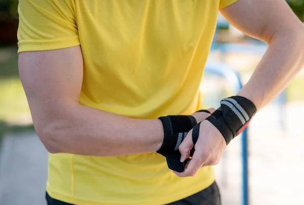 Elastic wrist bandage on male hands — Stock Photo, Image