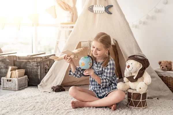 Усміхнена дівчинка грає з глобусом — стокове фото