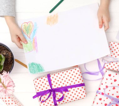 Elinde boş bir kağıt parçası var.