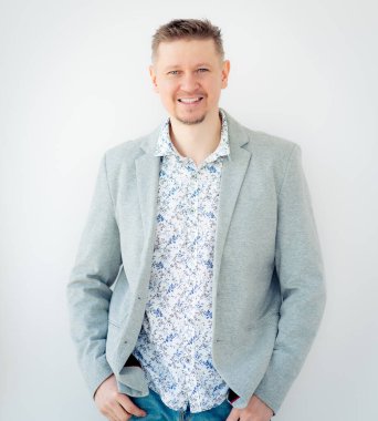 Gömlekli ve ceketli gülümseyen adam.