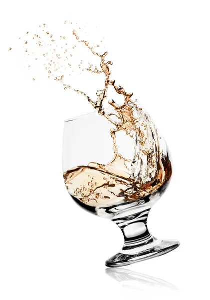 Cognac glass with splashing drink — Stock Photo, Image