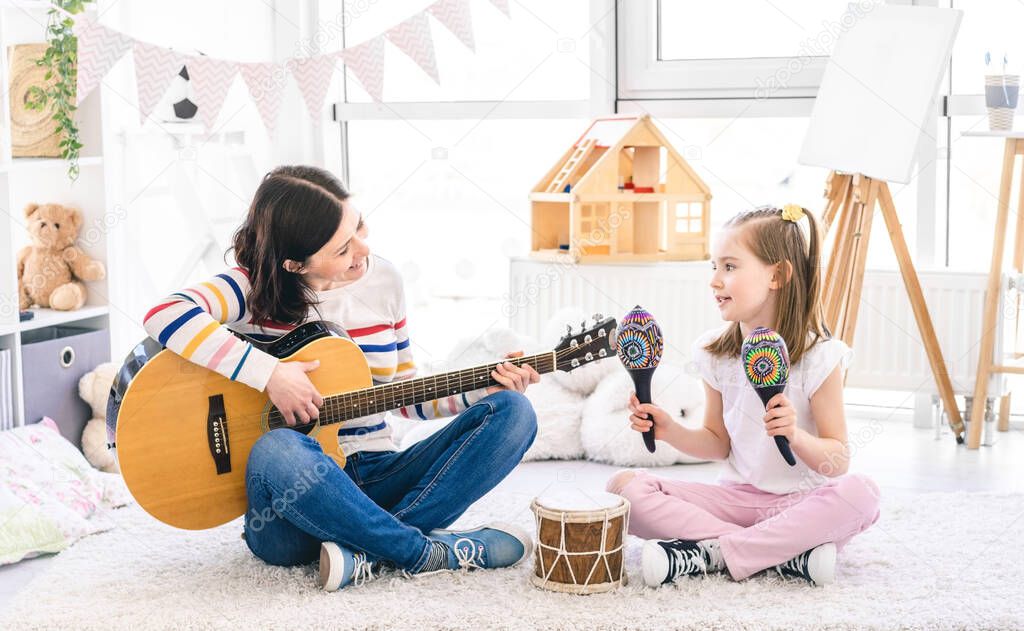 Woman singing with cute little girl